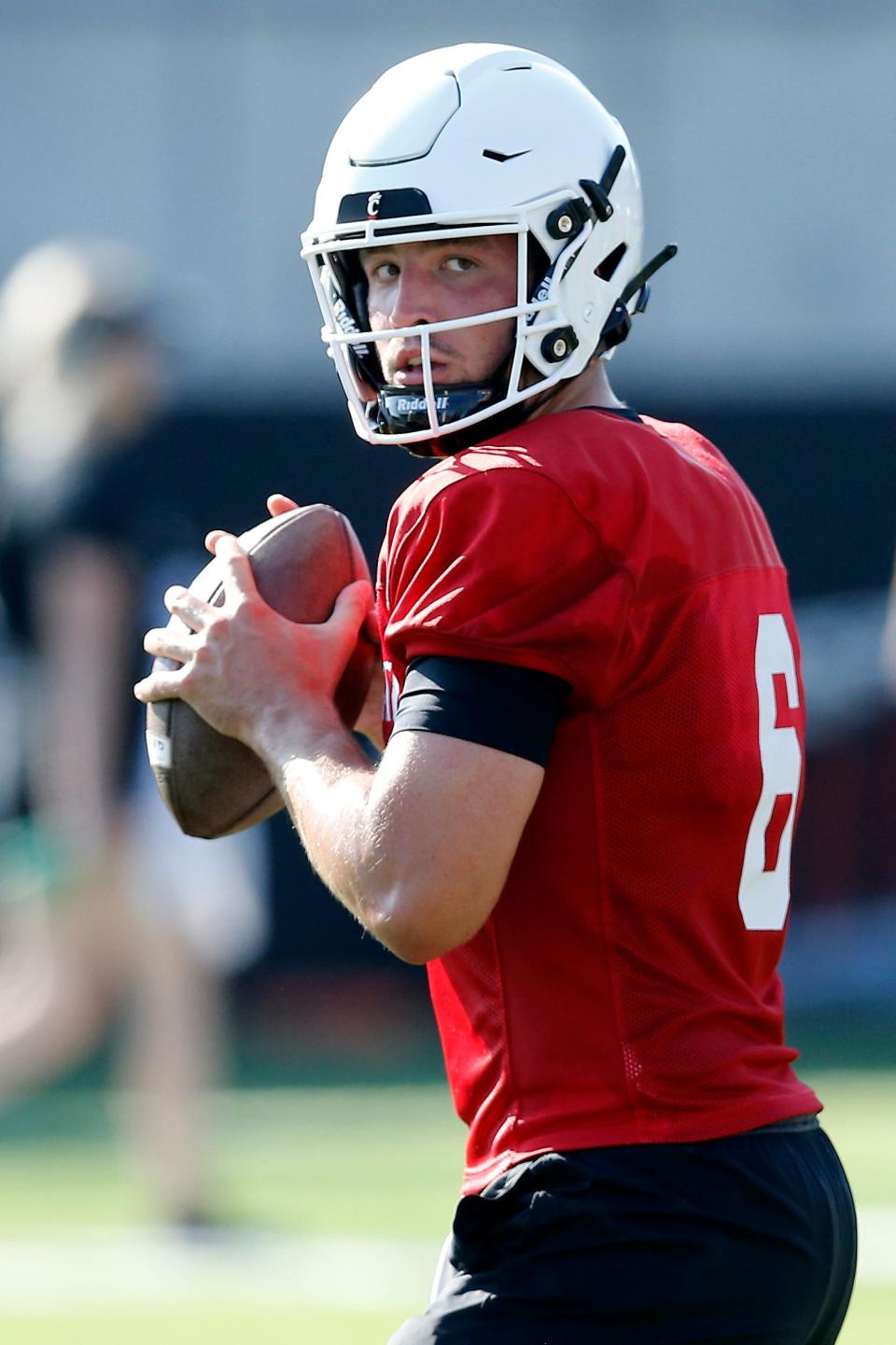 Bearcats quarterback Ben Bryant (6), dropping back to throw during the first day of preseason training camp at the University of Cincinnati’s Sheakley Athletic Complex, is a traditional pocket passer.