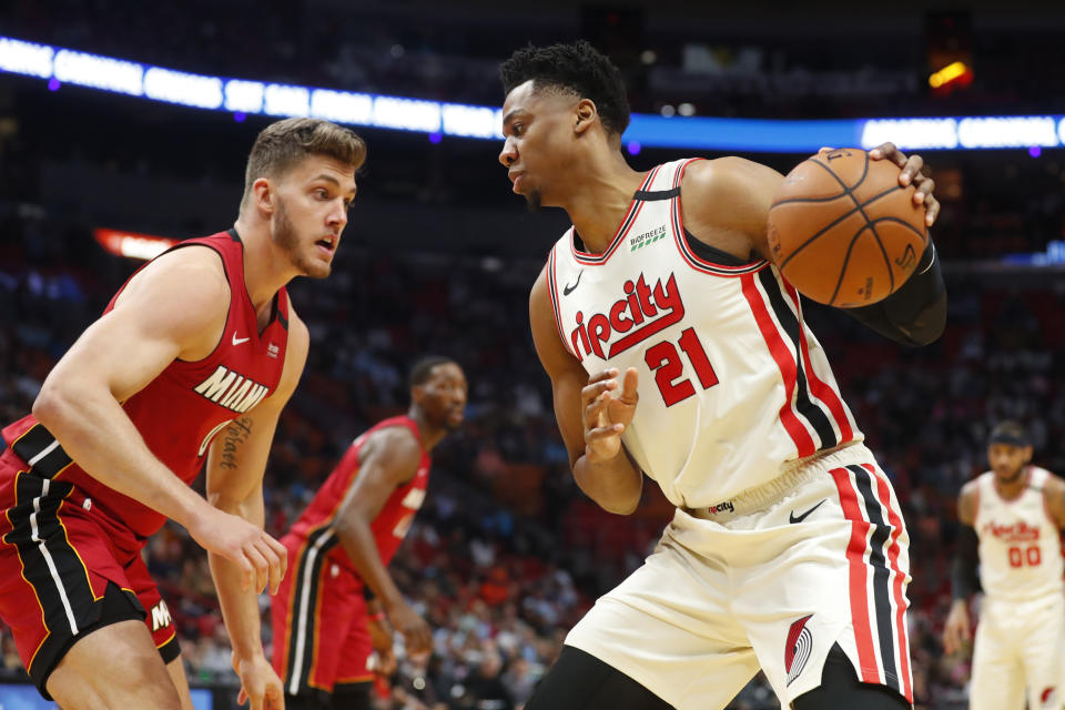 Portland Trail Blazers center Hassan Whiteside (21) drives up against Miami Heat forward Meyers Leonard (0) during the first half of an NBA basketball game, Sunday, Jan. 5, 2020, in Miami. (AP Photo/Wilfredo Lee)