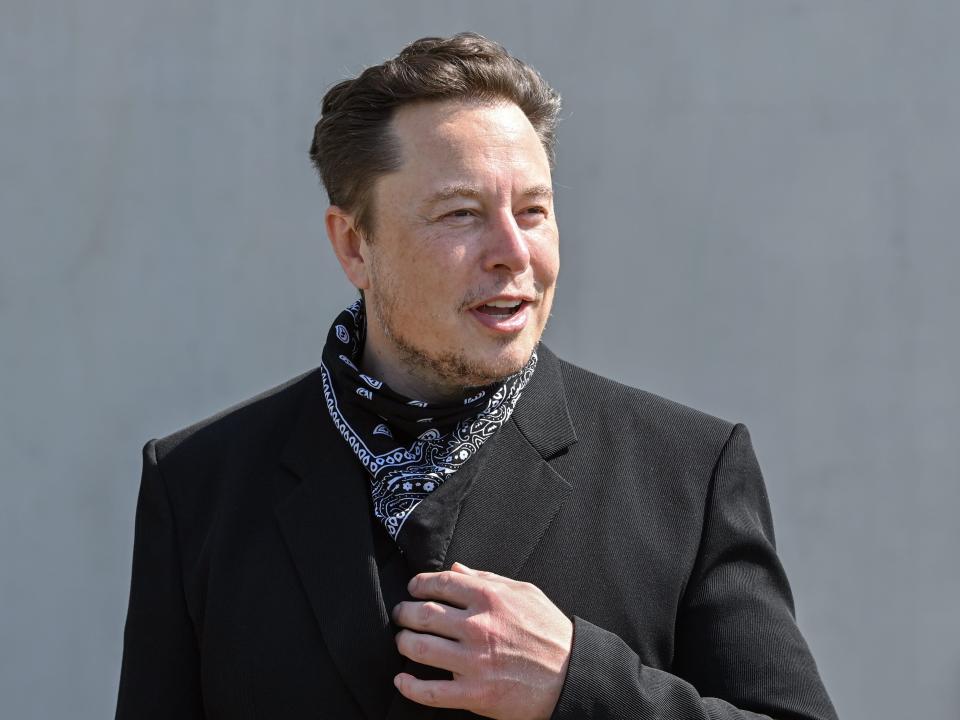 Elon Musk, Tesla CEO, stands at a press event on the grounds of the Tesla Gigafactory.
