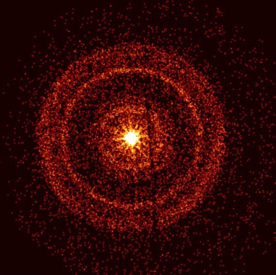 bright yellow gamma ray burst surrounded by rings of red dots