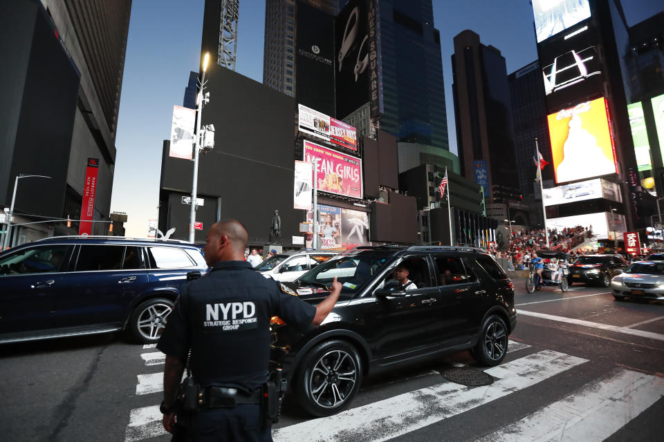 A police officer directs traffic in Times Square during a widespread power outage, Saturday, July 13, 2019, in the Manhattan borough of New York. Authorities say a transformer fire caused a power outage in Manhattan and left businesses without electricity, elevators stuck and subway cars stalled. (AP Photo/Michael Owens)