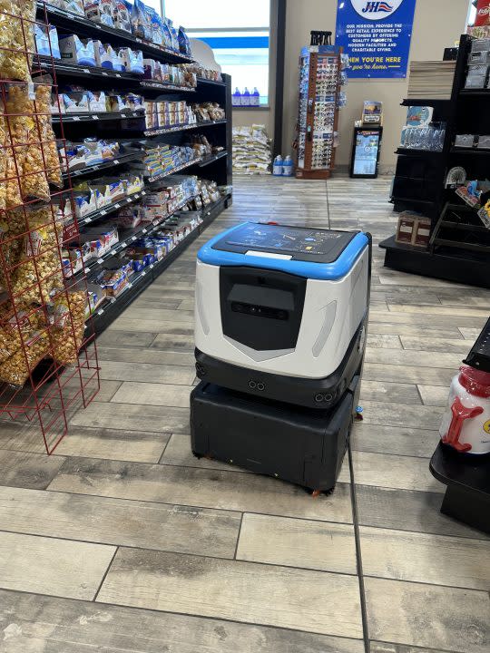 A robot cleans the floor at a J&H in Coopersville. (Feb. 12, 2024)