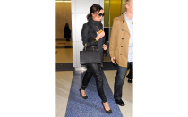 <p>The mom-to-be (who was a few months pregnant when this photo was taken) was stylish in simple black jeans, a blazer, sunglasses, and handbag from her collection. She completed the look with spiked Louboutin pumps.</p>