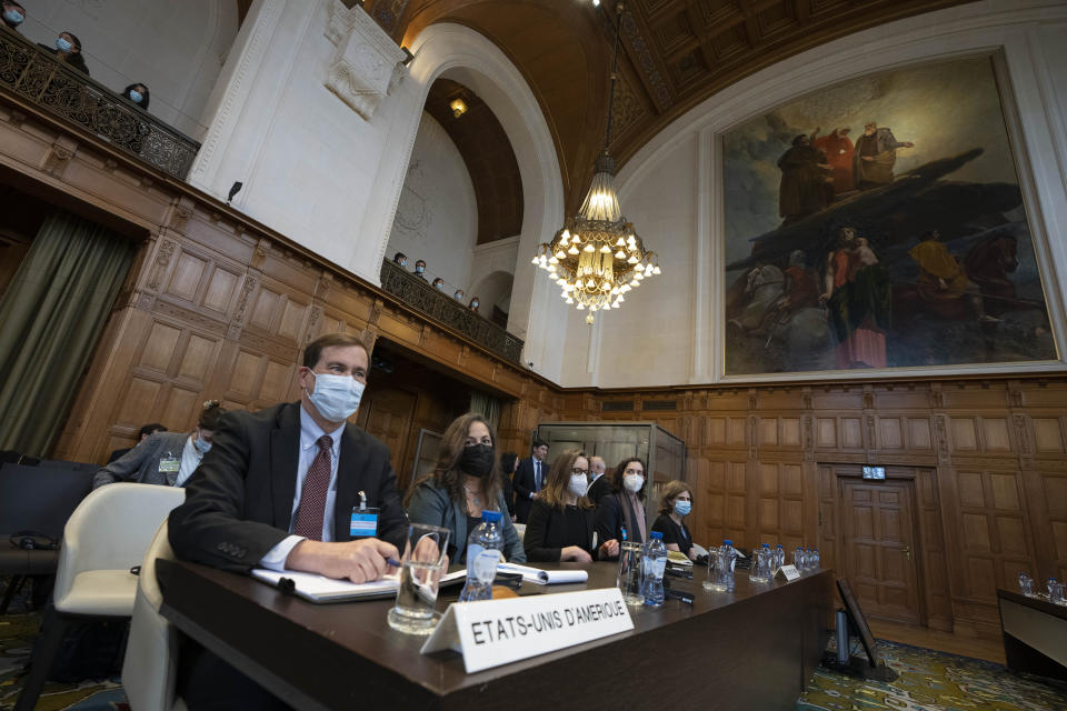 US agent Richard Visek, left, and delegation members, wait for judges to enter the International Court of Justice, the United Nations' top court, which issued its judgment in a dispute between Iran and the United States over frozen Iranian state bank accounts worth some $2 billion, in The Hague, Netherlands, Thursday, March 30, 2023. (AP Photo/Peter Dejong)