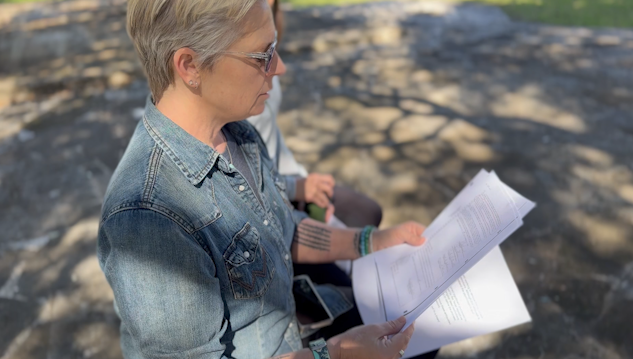 Jenell Pham reads home deed. (KXAN photos/Jala Washington).