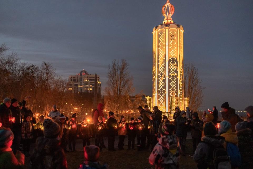 A group of children and adults hold candles as they pay tribute to the victims of the famine of 1932-1933, at the National Museum of the Holodomor Genocide in Kyiv, on Nov. 25, 2023. Ukraine marked 90 years since the artificial famine caused by the policies ordered by Joseph Stalin that killed millions of Ukrainians. (Roman Pilipey/AFP via Getty Images)