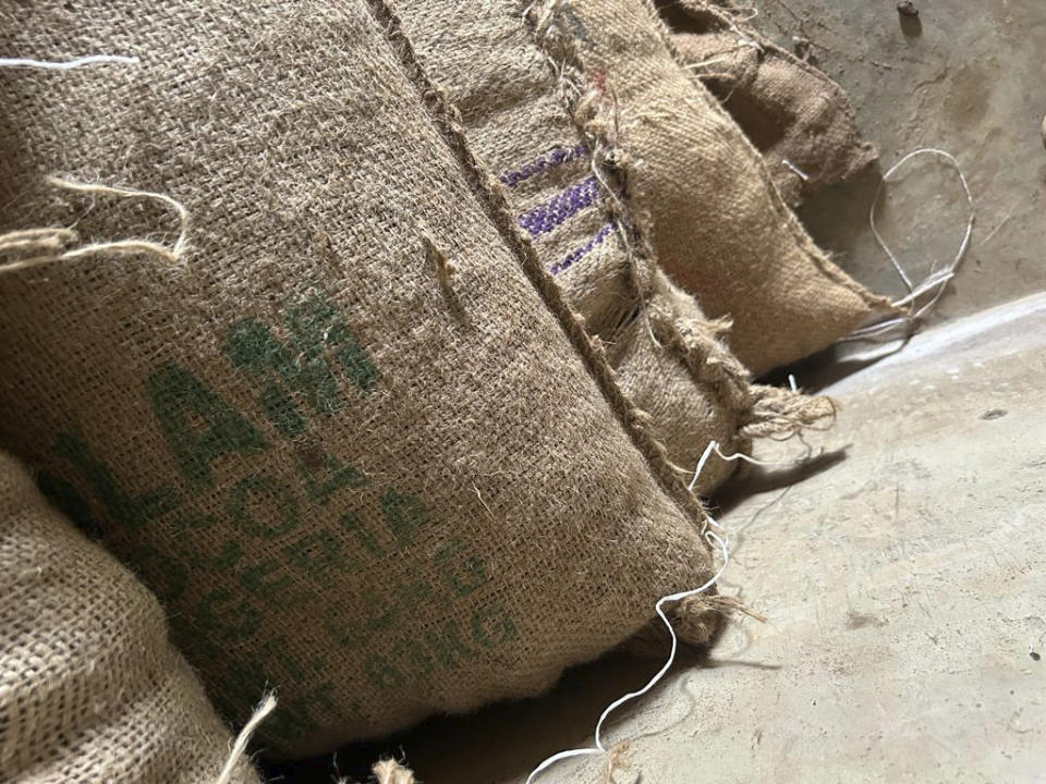 A bag marked Olam sits in a farmers' warehouse inside the conservation zone of Omo Forest Reserve on October 23, 2023. Farmers, buyers and others say cocoa heads from deforested areas of the protected reserve to companies that supply some of the world's biggest chocolate makers. (AP Photo/Taiwo Adebayo)