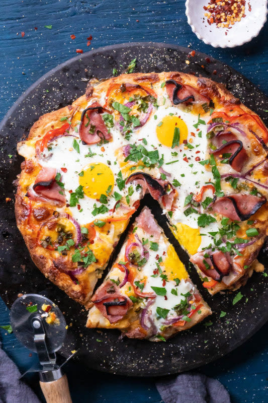<p>Eating Richly</p><p>Combines the classic flavors of a Denver omelet with eat-by-the-slice convenience.</p><p><strong>Get the recipe: <a href="https://eatingrichly.com/breakfast-pizza-recipe/" rel="nofollow noopener" target="_blank" data-ylk="slk:Ham, Egg and Cheese Breakfast Pizza;elm:context_link;itc:0;sec:content-canvas" class="link rapid-noclick-resp">Ham, Egg and Cheese Breakfast Pizza</a></strong></p>