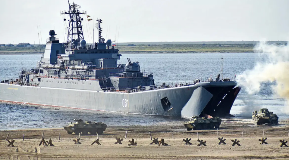 BTR-82 armored personnel carriers disembark from a <em>Ropucha</em> class landing ship during an exercise. <em>DENIS KOZHEVNIKOV/TASS VIA GETTY IMAGES</em>