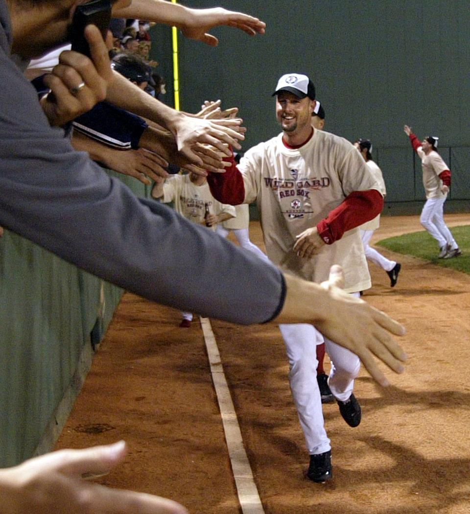 Boston Red Sox's Tim Wakefield shakes hands with  the crowd in celebration after the Red Sox clinched a playoff spot in the American League after defeating the Baltimore Orioles, Thursday, September 25, 2003.