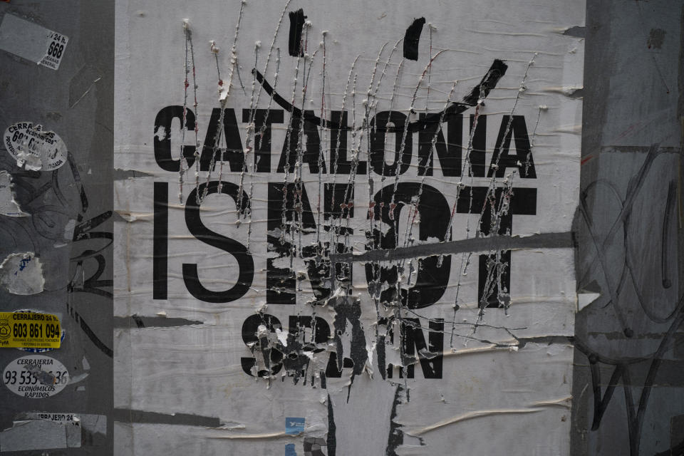 A damaged separatist poster decorates a wall near a polling station on the day of the general election in Badalona, Spain, Sunday, April 28, 2019. A divided Spain is voting in its third general election in four years, with all eyes on whether a far-right party will enter Parliament for the first time in decades and potentially help unseat the Socialist government. (AP Photo/Felipe Dana)