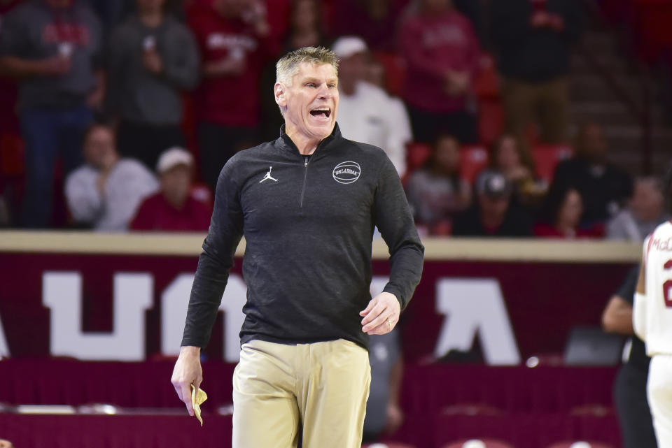 Oklahoma coach Porter Moser yells instructions to the team during the first half of an NCAA college basketball game against Green Bay, Saturday, Dec. 16, 2023, in Norman, Okla. (AP Photo/Kyle Phillips)