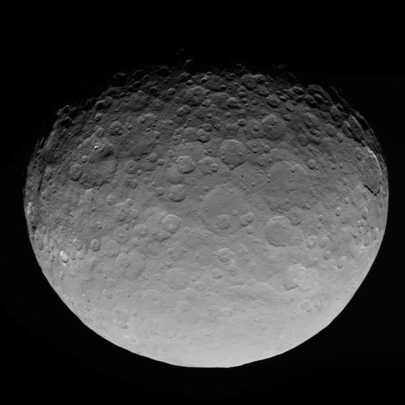 The dull, gray surface of the dwarf planet Ceres may come from graphite as organic material is bombarded by radiation from the sun.