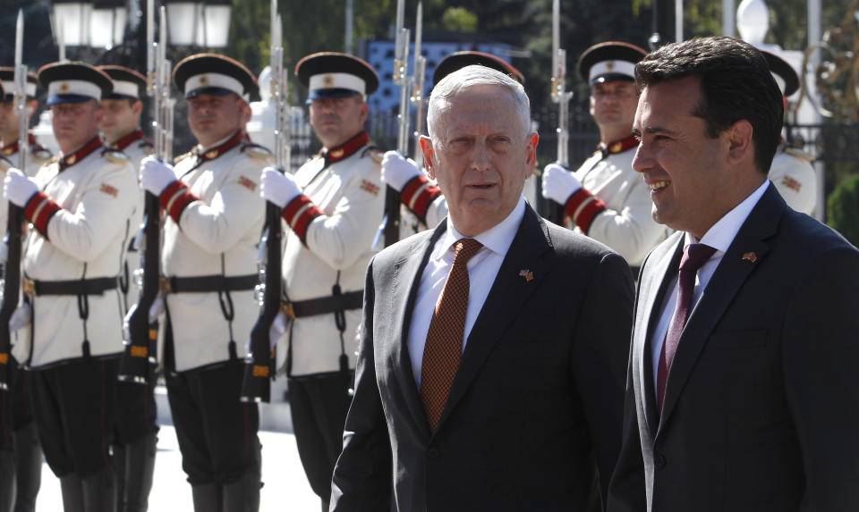 U.S. Defense Secretary James Mattis, center, accompanied by Macedonian Prime Minister Zoran Zaev, right, walks past an honor guard squad upon his arrival at the government building in Skopje, Macedonia, Monday, Sept. 17, 2018. UMattis arrived in Macedonia Monday, condemning Russian efforts to use its money and influence to build opposition to an upcoming vote that could pave the way for the country to join NATO, a move Moscow opposes. (AP Photo/Boris Grdanoski)