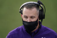 Northwestern head coach Pat Fitzgerald talks to players on the bench during the second half of an NCAA college football game against Iowa, Saturday, Oct. 31, 2020, in Iowa City, Iowa. (AP Photo/Charlie Neibergall)