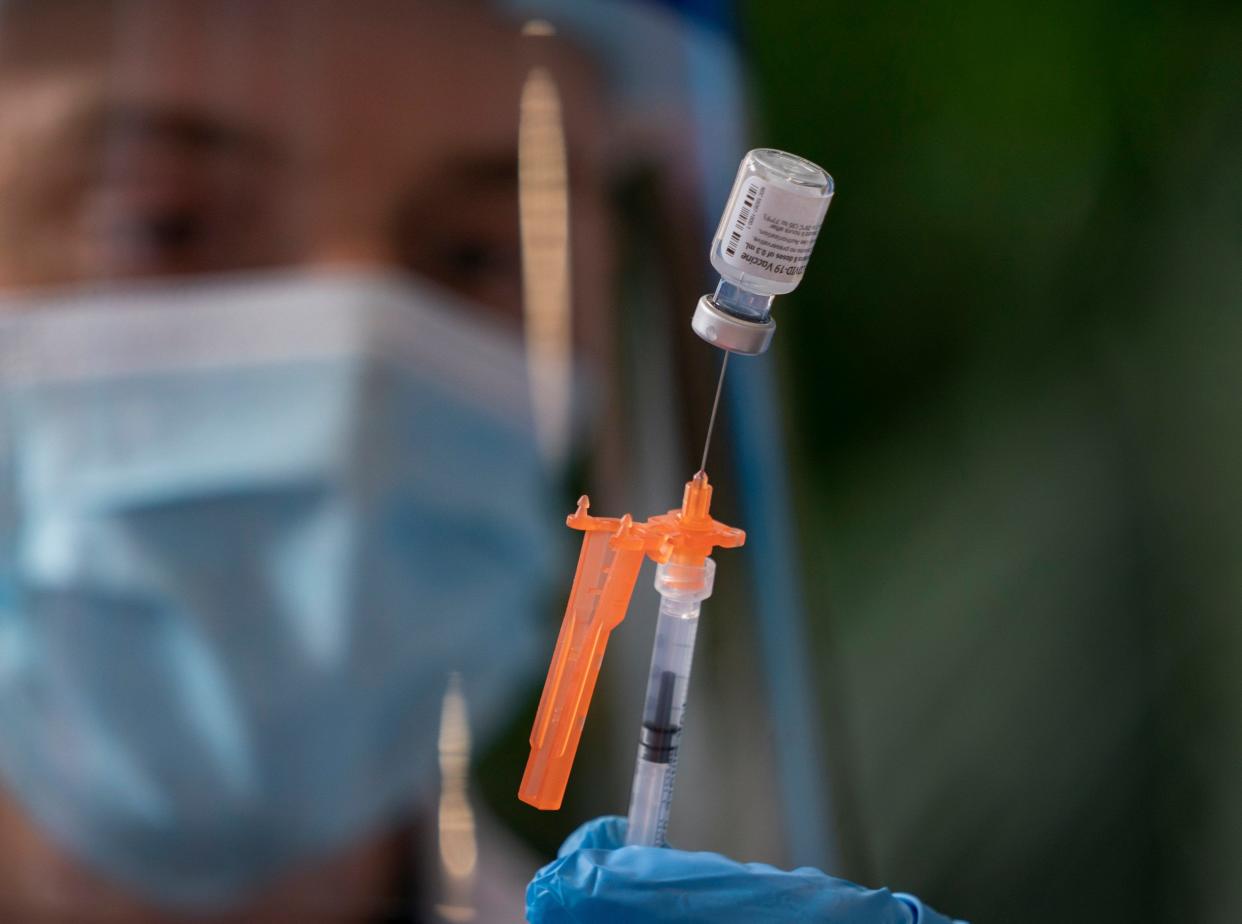 Christoffer Knight prepares a dose of the Pfizer COVID-19 vaccine at St. Mary's Medical Center in West Palm Beach in August 2021.