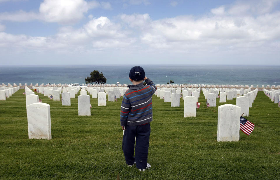 Nathaniel Marley, 4, salutes the graves of service men and women as well as his grandpa as he is taught to pay respects and say thank you by his father, U.S. Army veteran Bruce Marley, of San Diego, not pictured, on a Memorial Day weekend at Rosecrans National Cemetery overlooking the Pacific Ocean in Point Loma, San Diego.