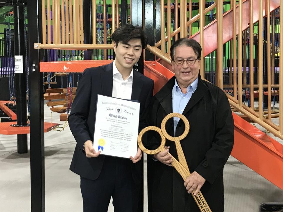 Fun City Adventure Park business partner Ethan Zhang, left, displays a congratulatory state Senate citation presented to him by School Committee member Lou Laura, a district director for state Sen. Marc Pacheco, on Tuesday, Jan. 10, 2023.
