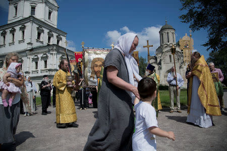Local churchgoers attend a procession organised by the Union of Orthodox Banner-Bearers to commemorate 100 years since the killing of Tsar Nicholas II, in Spaso-Andronikov Monastery in Moscow, Russia, July 17, 2018. REUTERS/Ekaterina Anchevskaya