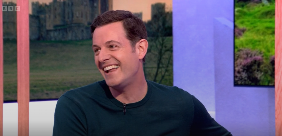 Matt Baker looked thrilled to be back on the sofa. (BBC screengrab)