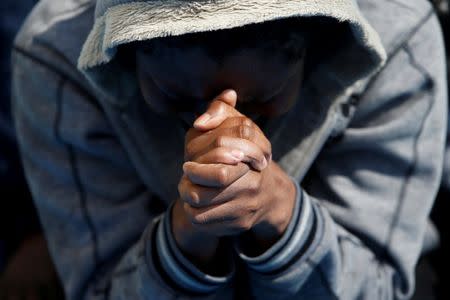 A migrant prays on the Migrant Offshore Aid Station (MOAS) ship Topaz Responder after being rescued around 20 nautical miles off the coast of Libya, June 23, 2016. Picture taken June 23, 2016.REUTERS/Darrin Zammit Lupi