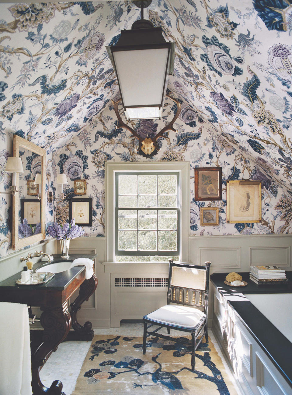 Bathroom with purple floral wallpaper and chair