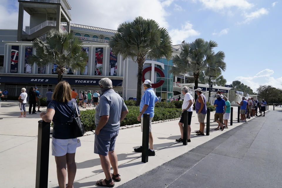 Minnesota Twins fans wait in line for tickets during spring training baseball practice on Wednesday, Feb. 24, 2021, in Fort Myers, Fla. (AP Photo/Brynn Anderson)