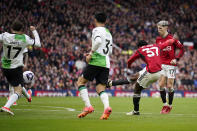 Manchester United's Kobbie Mainoo, second from right, scores his side's second goal during the English Premier League soccer match between Manchester United and Liverpool at the Old Trafford stadium in Manchester, England, Sunday, April 7, 2024. (AP Photo/Dave Thompson)