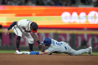 Los Angeles Dodgers' Trea Turner beats the tag by Atlanta Braves shortstop Dansby Swanson to steal second base during the fifth inning in Game 1 of baseball's National League Championship Series Saturday, Oct. 16, 2021, in Atlanta. (AP Photo/Ashley Landis)