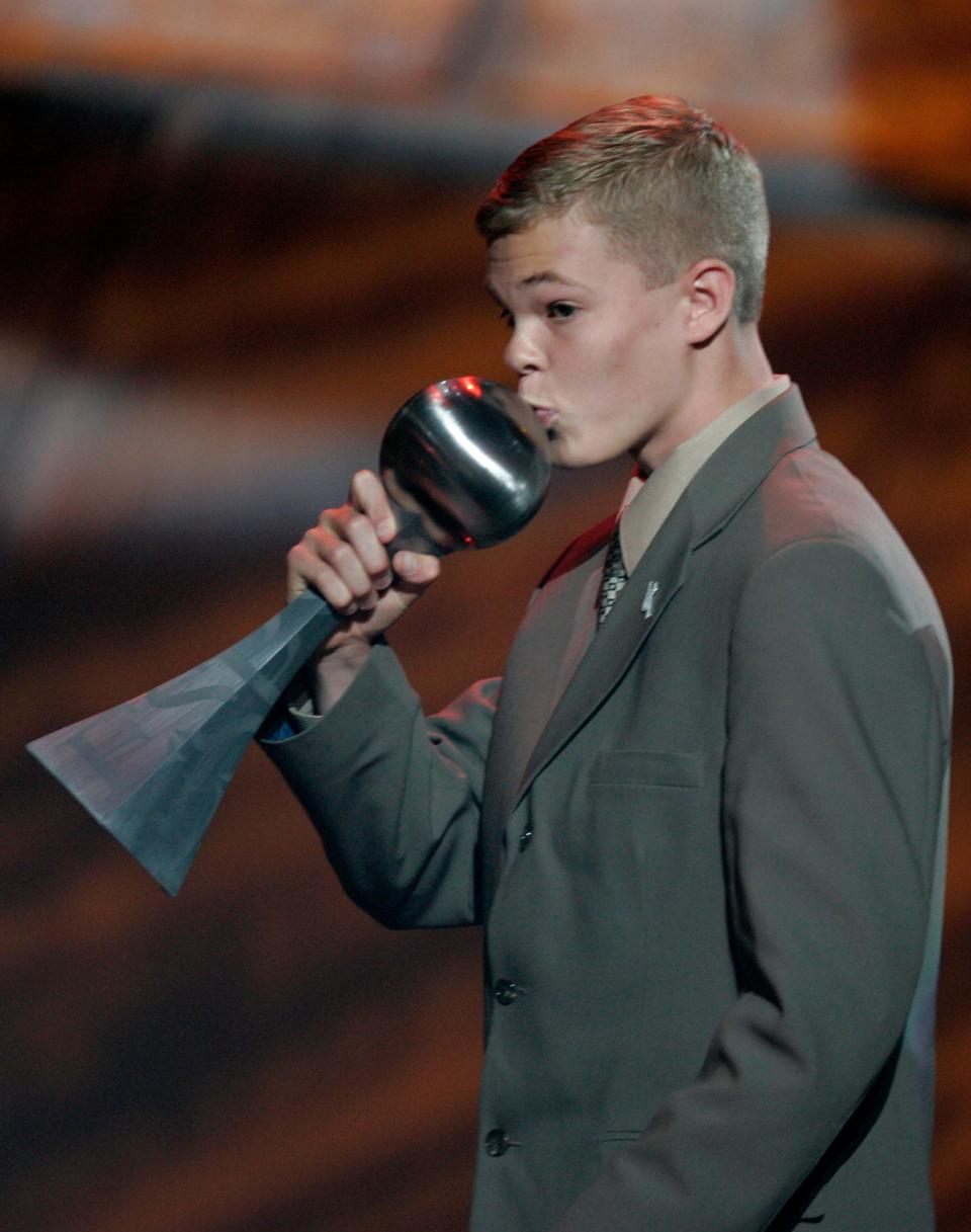 Jason McElwain from Greece Athena High School kisses his trophy for best moment at the 2006 ESPY Awards in Los Angeles on Wednesday, July 12, 2006.