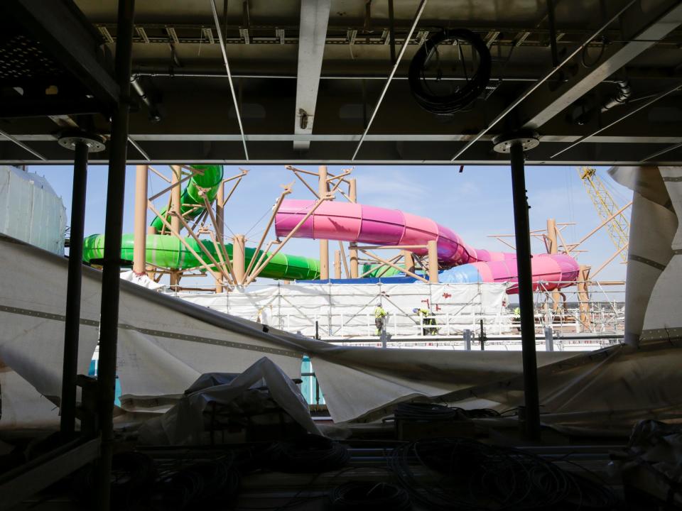 The Thrill Island neighborhood with water slides under scaffolding and tarps while it's being constructed on Royal Caribbean's Icon of the seas