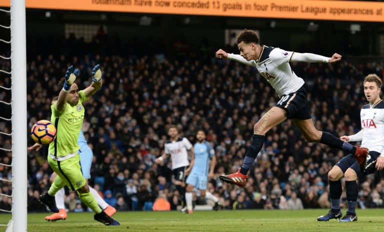 Tottenham Hotspur's midfielder Dele Alli (2nd R) jumps to head their first goal past Manchester City's goalkeeper Claudio Bravo on January 21, 2017