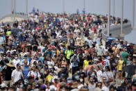 Spectators walk from their vantage point on a bridge in Titusville, Fla. after watching SpaceX Falcon 9 lift off with NASA astronauts Doug Hurley and Bob Behnken in the Dragon crew capsule, Saturday, May 30, 2020 from the Kennedy Space Center at Cape Canaveral, Fla. The two astronauts are on the SpaceX test flight to the International Space Station. For the first time in nearly a decade, astronauts blasted towards orbit aboard an American rocket from American soil, a first for a private company. (AP Photo/Charlie Riedel)