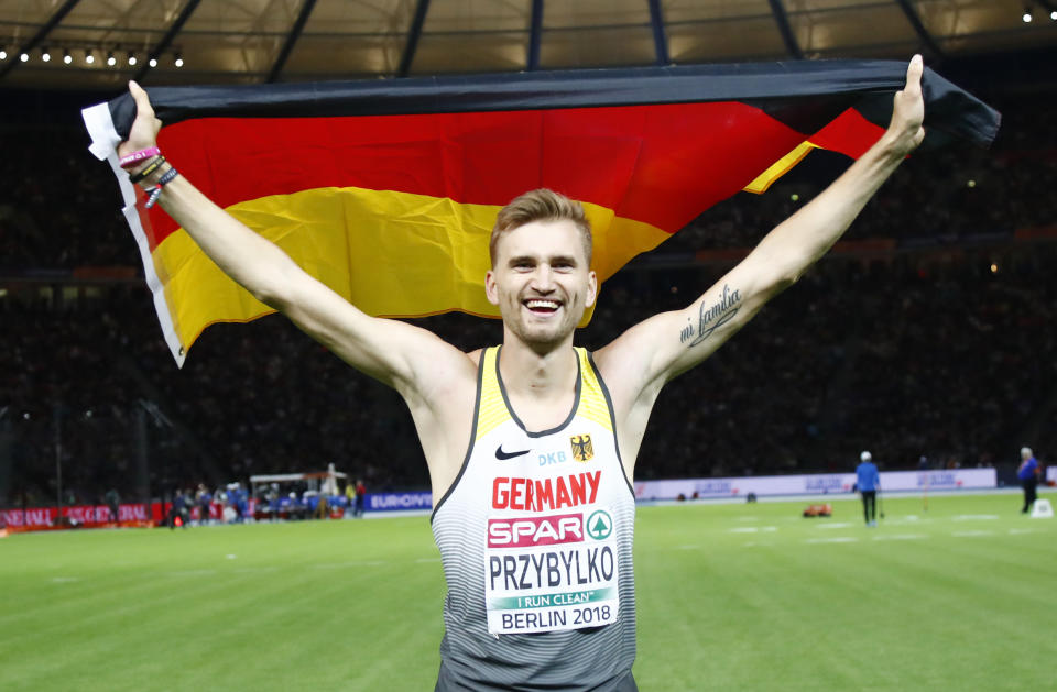 Germany's Mateusz Przybylko celebrates after winning the gold medal after the men's high jump final at the European Athletics Championships at the Olympic stadium in Berlin, Germany, Saturday, Aug. 11, 2018. (AP Photo/Matthias Schrader)