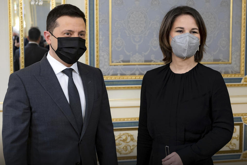 In this photo provided by Ukrainian Presidential Press Office, Ukrainian President Volodymyr Zelenskyy, left, and German Foreign Minister Annalena Baerbock pose for a photo during their meeting in Kyiv, Ukraine, Monday, Jan. 17, 2022. (Ukrainian Presidential Press Office via AP)