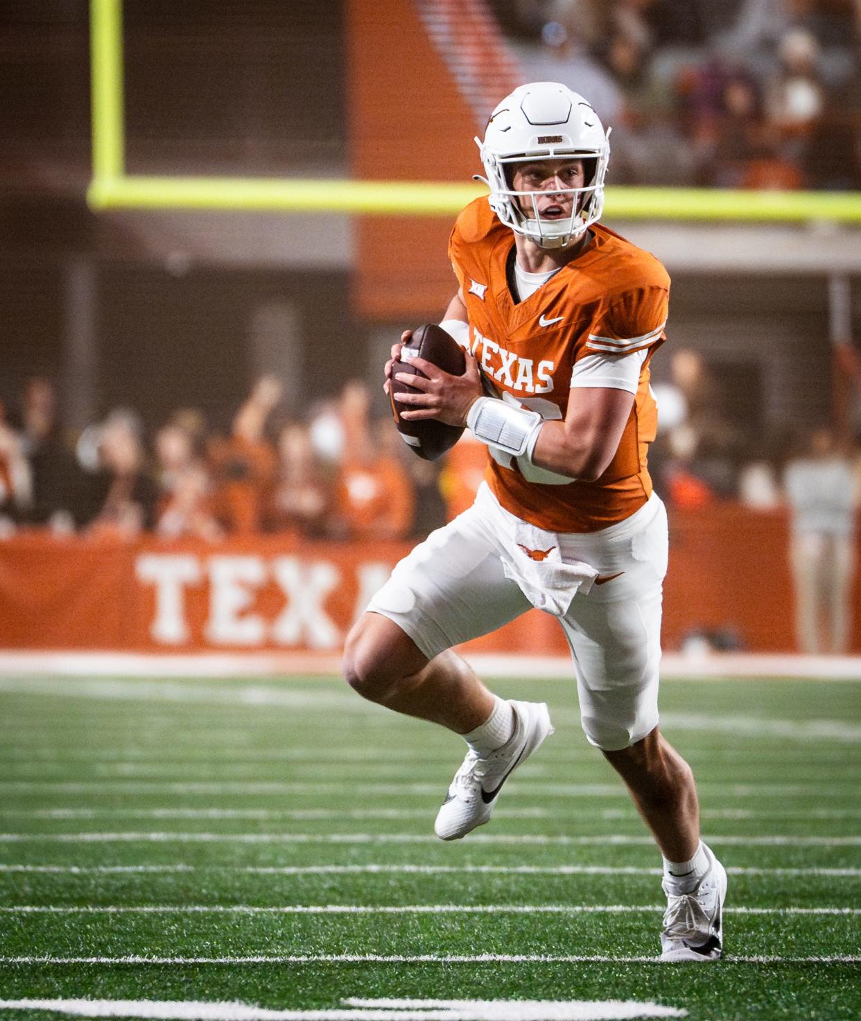 Texas quarterback Arch Manning (16) looks for a teammate while carrying the ball in the fourth quarter of the Longhorns' game against the Texas Tech Red Raiders, Friday, Nov. 24, 2023 at Darrell K Royal-Texas Memorial Stadium in Austin.