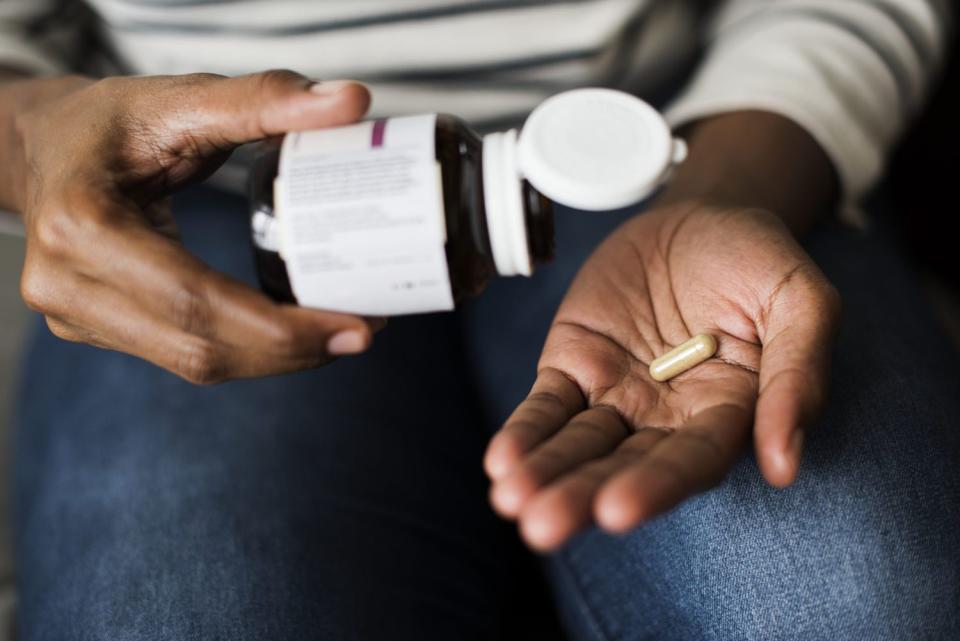 woman taking probiotic supplement