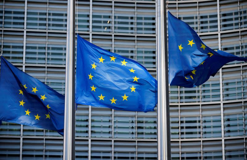 FILE PHOTO: European Union flags fly outside the European Commission headquarters in Brussels