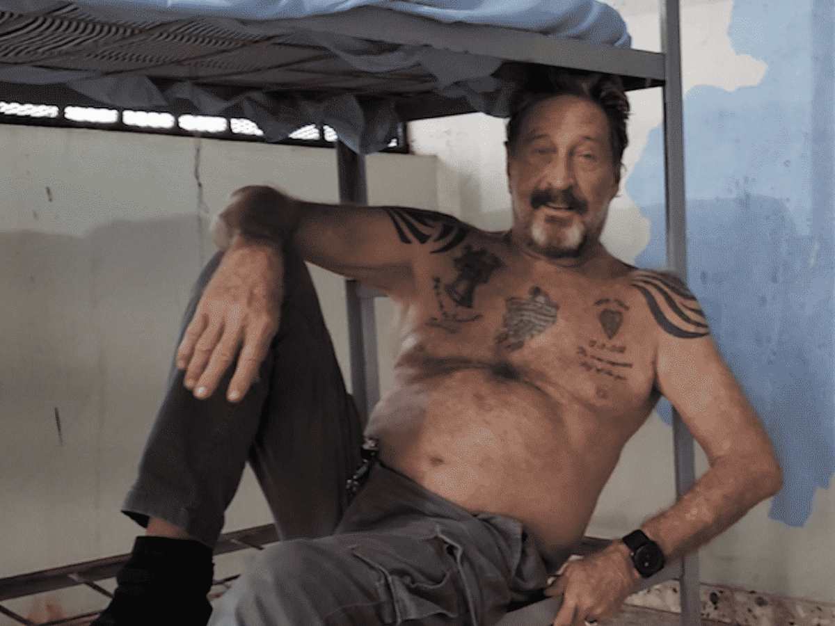 John McAfee, pictured here in a prison cell in the Caribbean, was found dead in a Spanish prison cell on 23 June, 2021 (Netflix/ Screengrab)