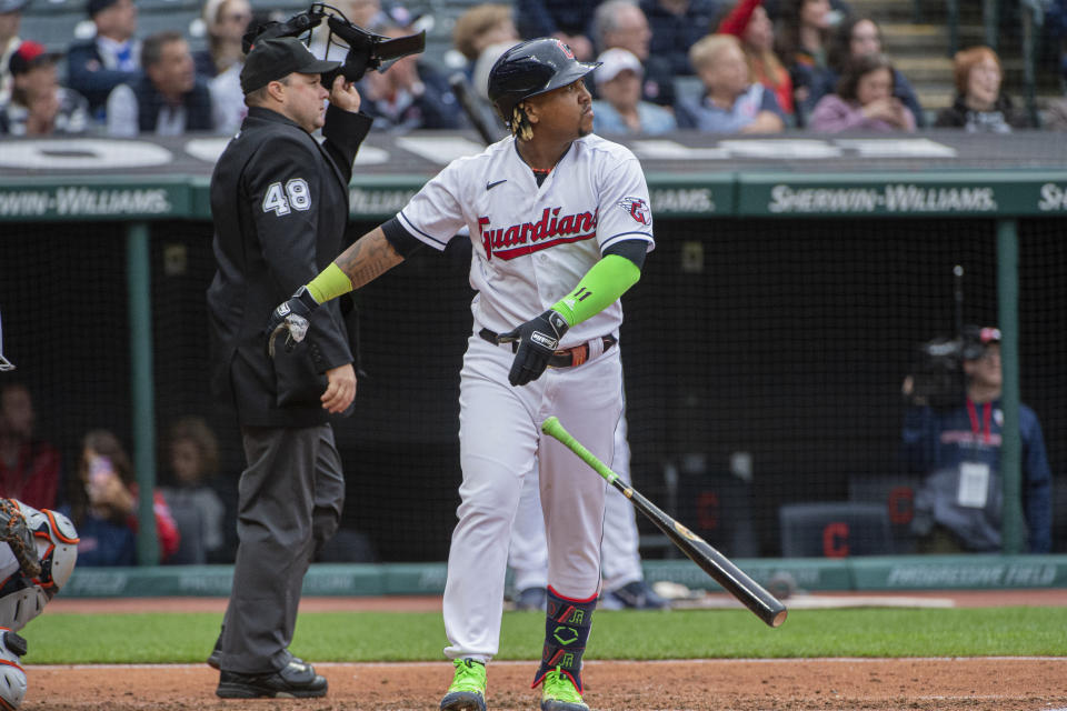 Cleveland Guardians' Jose Ramirez, right, watches his solo home run off Detroit Tigers starting pitcher Joey Wentz with umpire Nick Mahrley (48) during the fourth inning of a baseball game in Cleveland, Monday, May 8, 2023. (AP Photo/Phil Long)