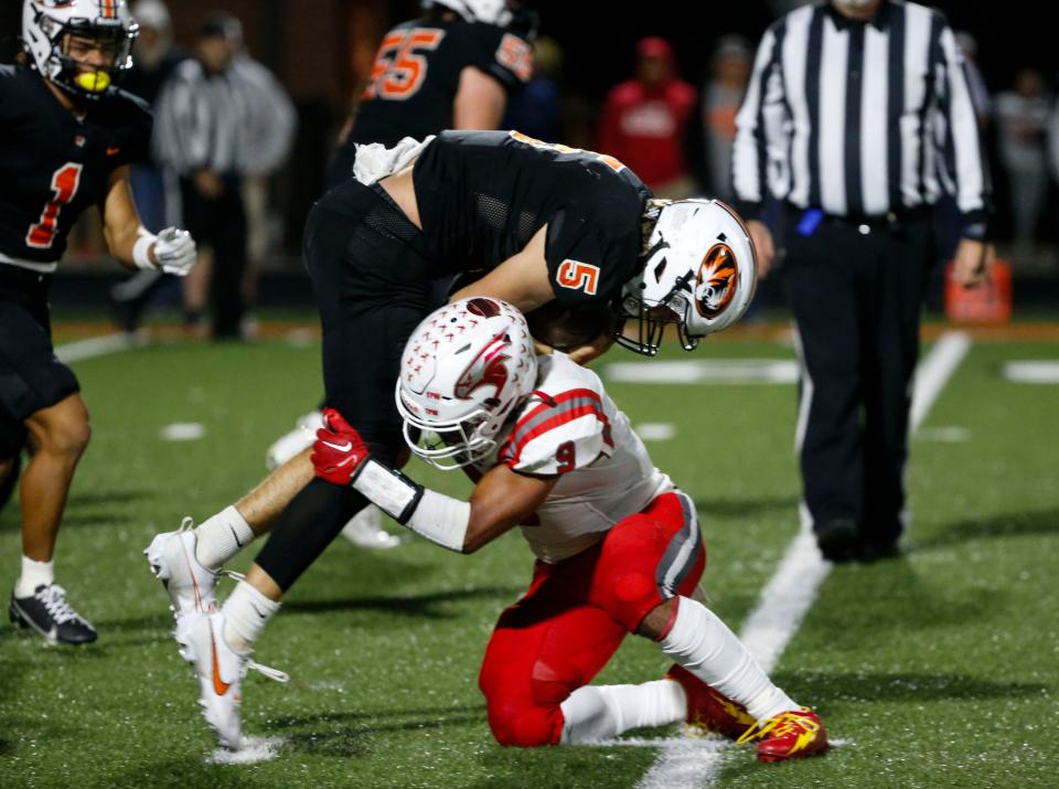 Nixa's Spencer Ward makes a tackle of Republic's Wyatt Woods during a game at Republic on Friday, Oct. 13, 2023.