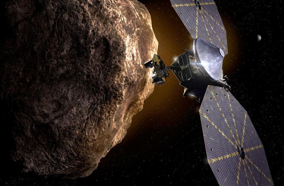 An artist's impression of the Lucy probe as it flies past a Trojan asteroid. / Credit: NASA