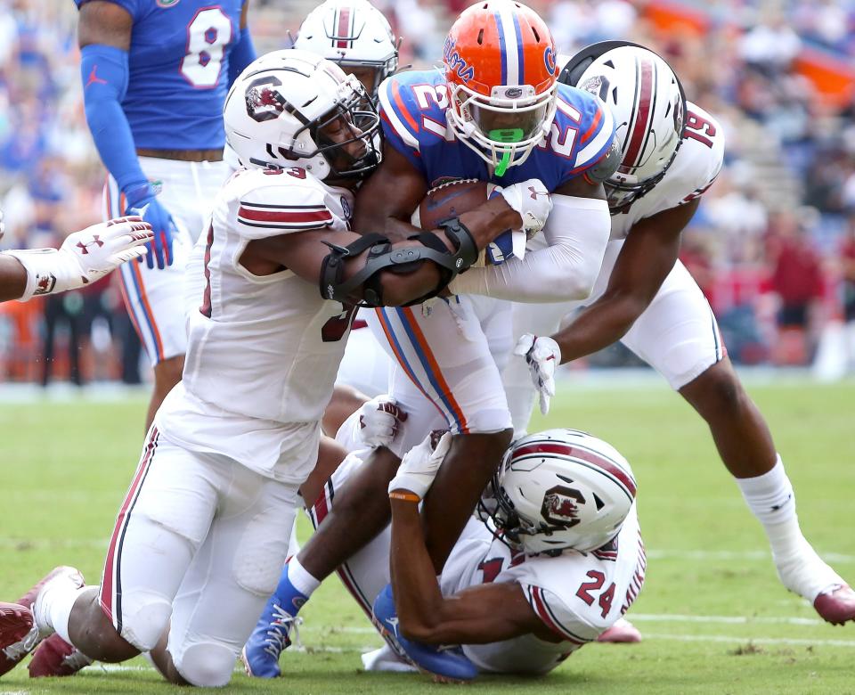 University of Florida Gators running back Dameon Pierce (27) is gang tackled as he runs with the ball near the end zone during a game against South Carolina at Ben Hill Griffin Stadium, in Gainesville, Fla. Oct. 3, 2020.  [Brad McClenny/The Gainesville Sun]