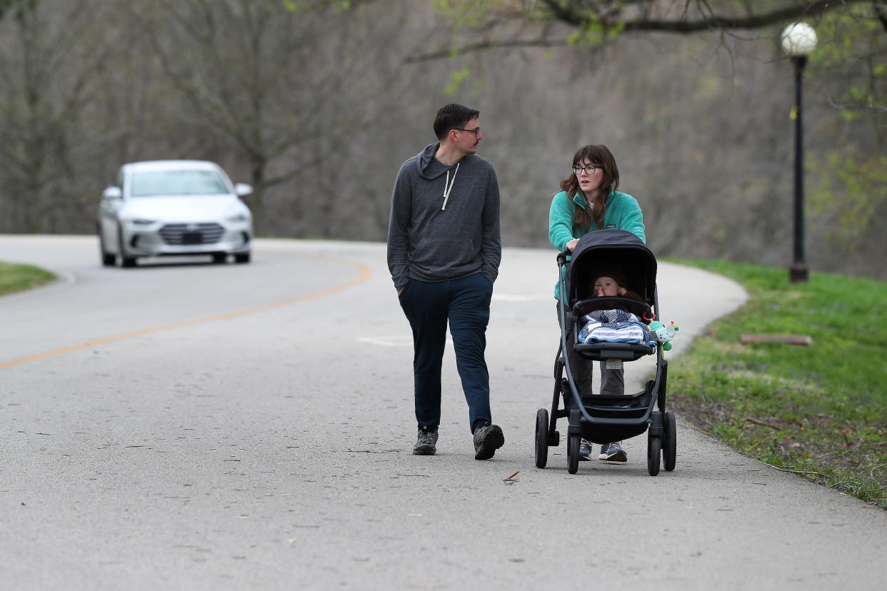 Adam Collins, left, and Tess Collins take an afternoon stroll along the Scenic Loop near the Cherokee Golf Course in Louisville, Ky. on April 17, 2022.  There is discussion about converting the golf course into a walking trail.