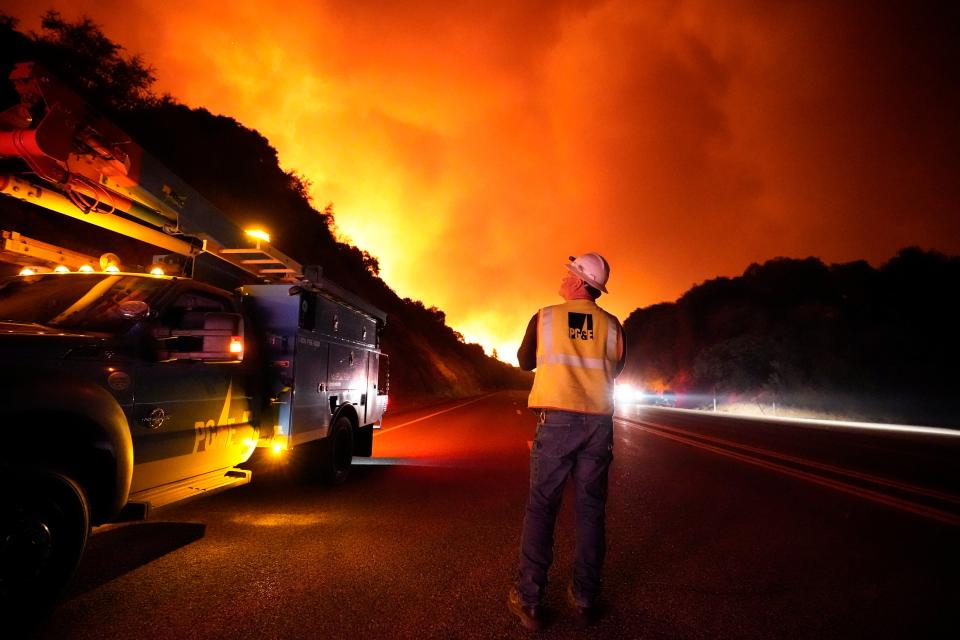 A PG&E electricity worker is seen surveying the Creek Fire, which blazed across swathes of California in September (Copyright 2020 The Associated Press. All rights reserved.)