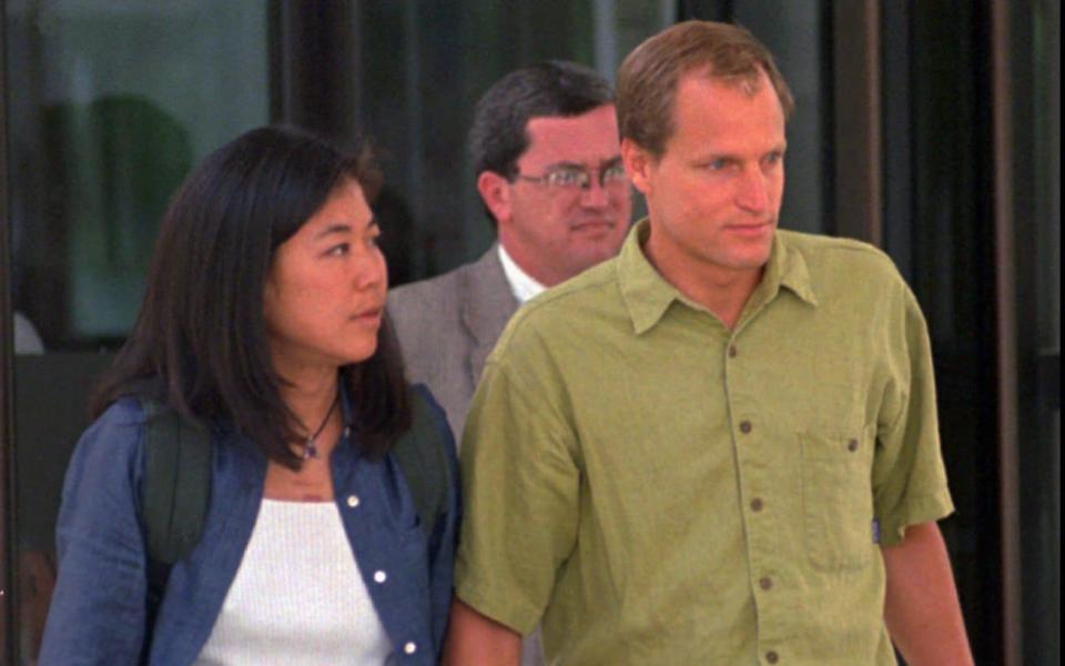 Woody Harrelson, with his wife Laura Louie, leaving a hearing for his father in Denver, 1998 - AP