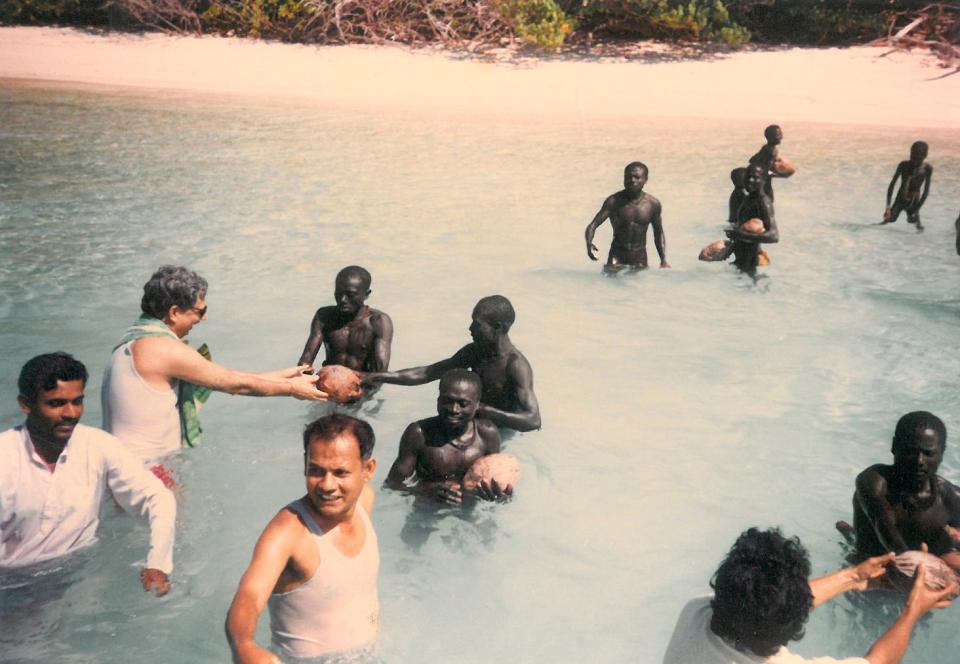 Indian anthropologists pass coconuts to the Sentinelese in 1991—one of the most notable attempts at contact to date.