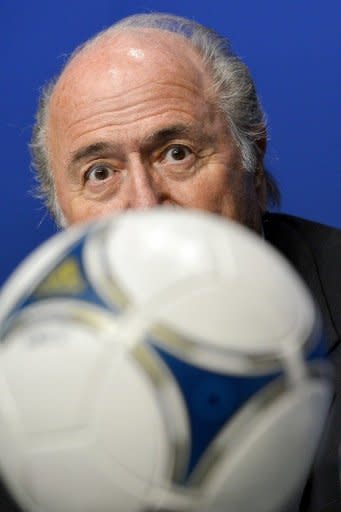 FIFA President Sepp Blatter looks on behind a ball during a press conference at the headquarters of football's world governing body in Zurich. Blatter on Tuesday announced that world football's governing body has adopted a new code of ethics in the wake of a series of damaging corruption scandals