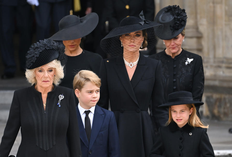 LONDON, ENGLAND - SEPTEMBER 19: (L-R) Camilla, Queen Consort, Meghan, Duchess of Sussex, Prince George of Wales, Catherine, Princess of Wales, Princess Charlotte of Wales and Sophie, Countess of Wessex during the State Funeral of Queen Elizabeth II at Westminster Abbey on September 19, 2022 in London, England. Elizabeth Alexandra Mary Windsor was born in Bruton Street, Mayfair, London on 21 April 1926. She married Prince Philip in 1947 and ascended the throne of the United Kingdom and Commonwealth on 6 February 1952 after the death of her Father, King George VI. Queen Elizabeth II died at Balmoral Castle in Scotland on September 8, 2022, and is succeeded by her eldest son, King Charles III. (Photo by Karwai Tang/WireImage)