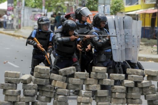 Riot police agents clash with students in front of the Engineering University during an April protest against government's social security reforms